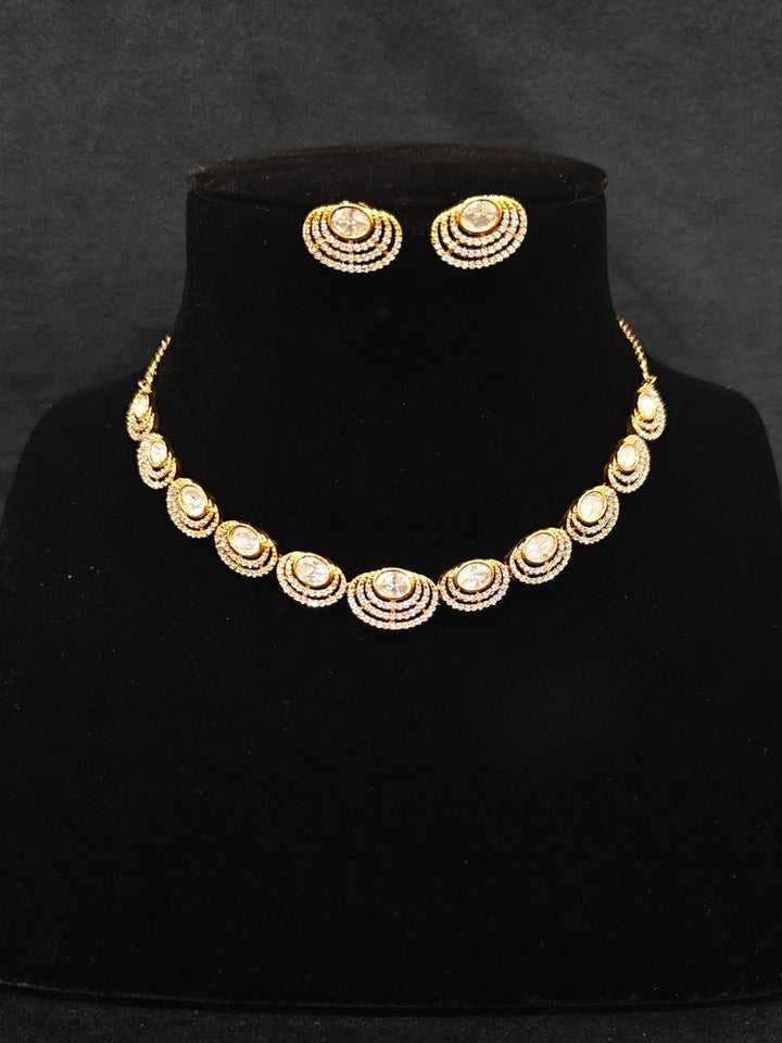 Close-up of an ornate Indo-western American Diamond gold Collar jewellery set and earrings with American Diamond and Monalisa Stones. Close-up of a cocktail party look featuring a premium American diamond necklace.
Festive celebration look featuring an American Diamond artificial necklace.