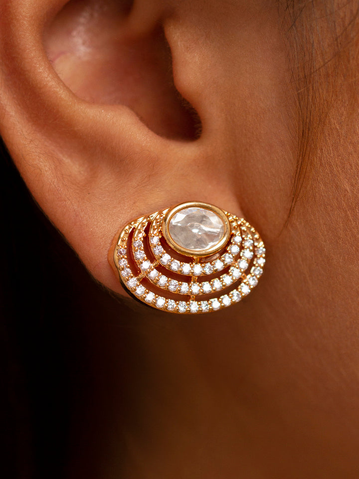 The Alice Necklace Set features a gold moissanite necklace with matching earrings, showcasing oval stones in circular designs made with moissanite, put on a teal velvet bust—perfect for elevating your cocktail jewelry style.