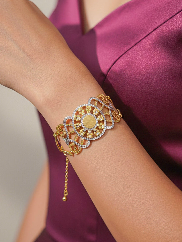 Close-up of a woman wearing an ornate traditional (Gold & Silver Polish) Bracelet. Close-up of an anti-tarnish artificial bracelet styled for wedding guests. Festive outfit paired with a premium imitation bracelet in India. 