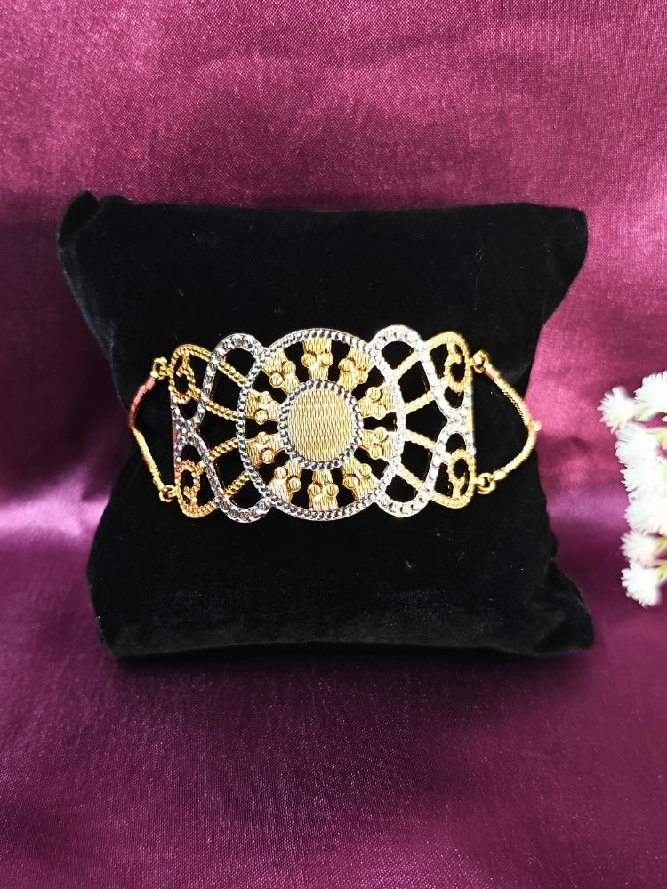Close-up of an ornate traditional (Gold & Silver Polish) Bracelet. Close-up of an anti-tarnish artificial bracelet styled for wedding guests. Festive outfit paired with a premium imitation bracelet in India. 