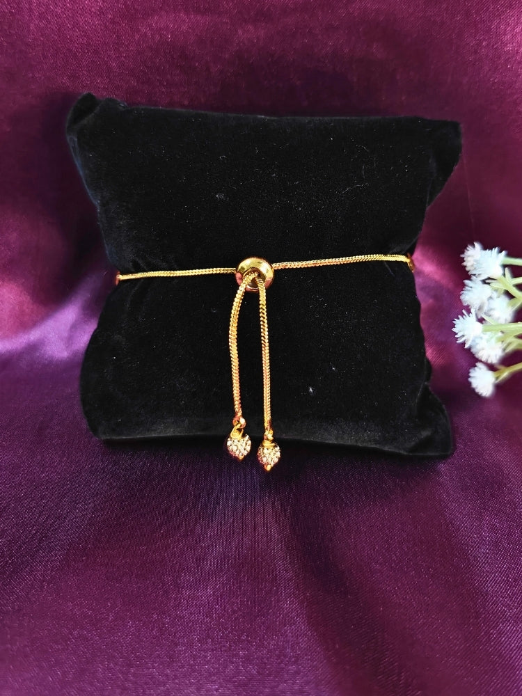 Close-up of an ornate traditional (Gold & Silver Polish) Bracelet. Close-up of an anti-tarnish artificial bracelet styled for wedding guests. Festive outfit paired with a premium imitation bracelet in India. 
