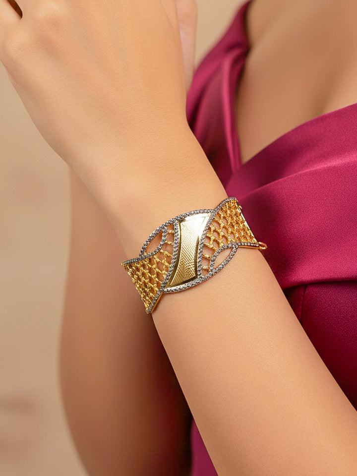 Close-up of a woman wearing an ornate traditional (Gold & Silver Polish) Bracelet. Close-up of an anti-tarnish artificial bracelet styled for wedding guests. Festive outfit paired with a premium imitation bracelet in India. 