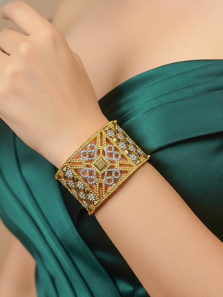 Close-up of a woman wearing an ornate traditional (Gold & Silver Polish) Bracelet. Close-up of an anti-tarnish artificial bracelet styled for wedding guests. Festive outfit paired with a premium imitation bracelet in India. 