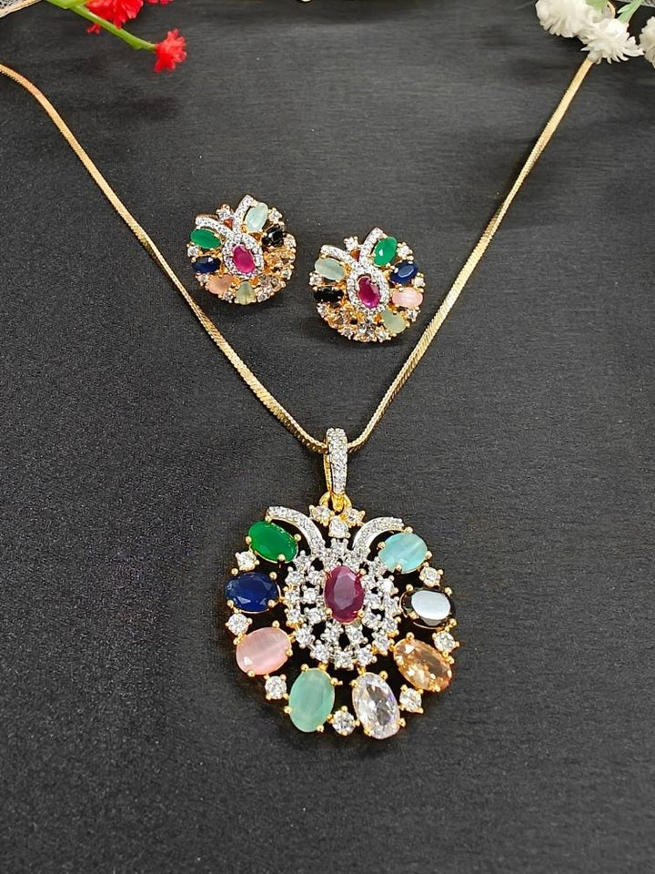 Close-up of an ornate Indo-Western Navratan (gold Polish) Pendant Set with American Diamond and Navratan Colored Stones. Elegant festive look with a high-quality imitation American diamond Pendant set. Indo-western outfit styled with a statement American diamond  Pendant set.