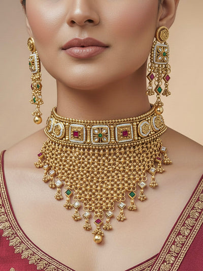 Close-up of a woman wearing an ornate traditional Rajwadi gold Choker jewellery set and earrings with Brass, Stones, Pearls and Bandhai Work. Festive look completed with a luxury Rajwadi imitation necklace. Model wearing a royal Rajwadi necklace set for festive celebrations in India.