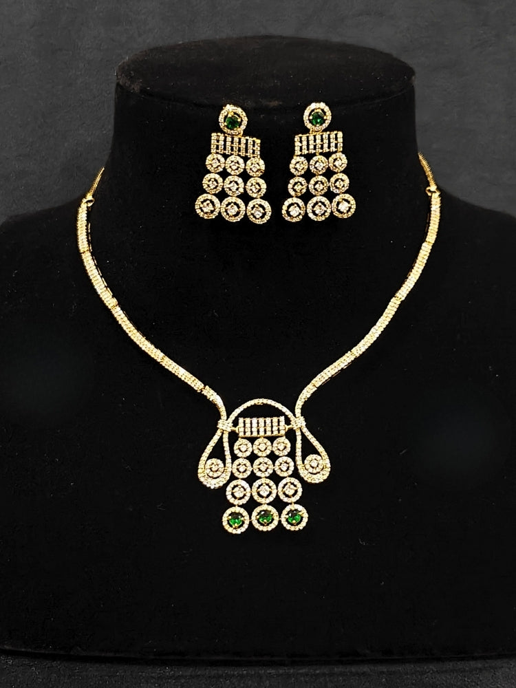 An elegant artificial diamond necklace with green colored stone and matching earrings. This premium artificial diamond jewelry set is perfect for special occasions, from Indian weddings to engagement parties, offering sophisticated glamour without the high price tag.