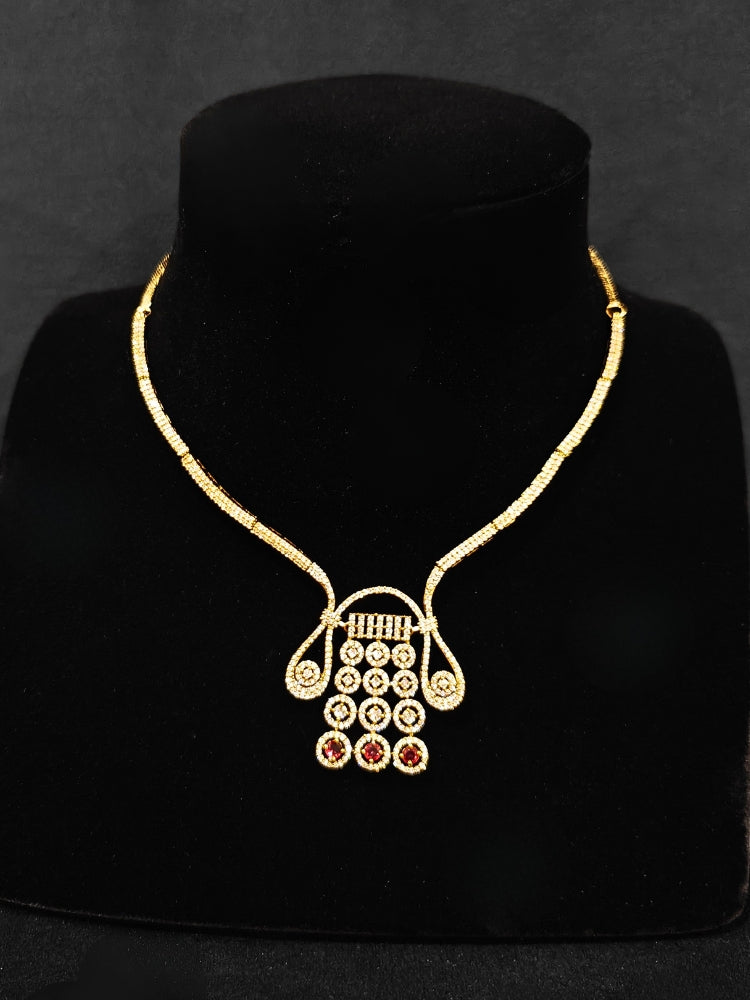 A luxurious artificial diamond necklace with red colored stone and matching earrings, perfect for high-profile wedding receptions and formal galas. This high-end artificial diamond jewelry set combines style, elegance, and affordability for special occasions.