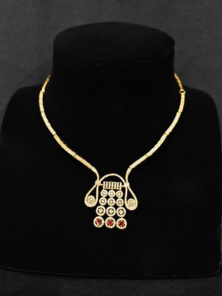 A luxurious artificial diamond necklace with red colored stone and matching earrings, perfect for high-profile wedding receptions and formal galas. This high-end artificial diamond jewelry set combines style, elegance, and affordability for special occasions.