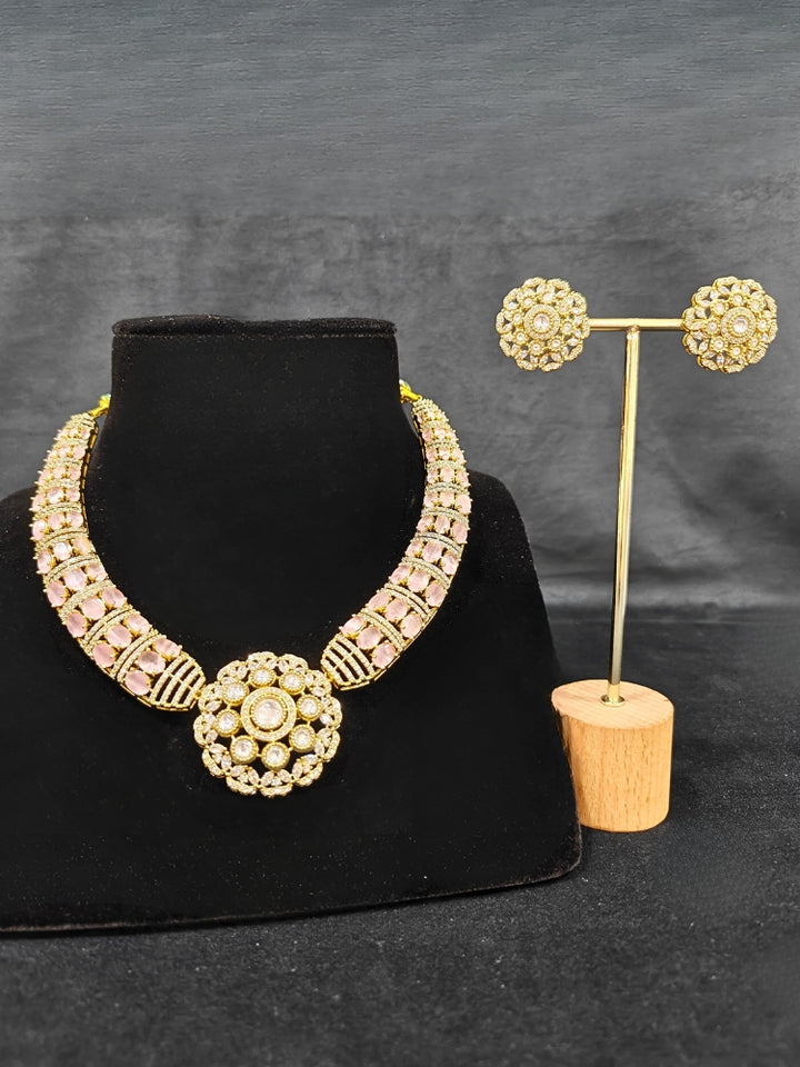 Close-up of a woman wearing an ornate traditional Mint Pink Collar Gold jewellery set and earrings with American Diamond and Colored Stones. Mehendi function outfit styled with a lightweight American Diamond necklace. Festive celebration look featuring a American Diamond artificial necklace.