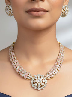 "A stunning woman wearing a glamorous artificial diamond and mint pink colored stone necklace paired with chic earrings, perfect for bridal wear. This high-quality artificial diamond jewelry set is the ideal choice for modern brides looking for a budget-friendly option with timeless sparkle."

