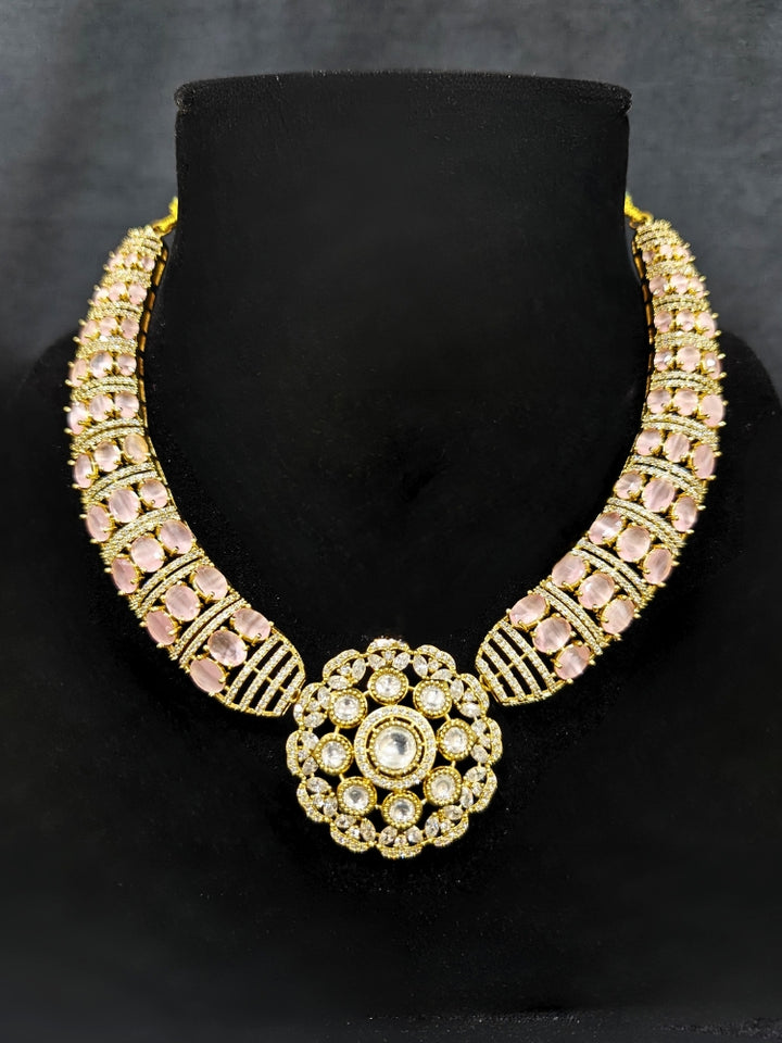 Close-up of a woman wearing an ornate traditional Mint Pink Collar Gold jewellery set and earrings with American Diamond and Colored Stones. Mehendi function outfit styled with a lightweight American Diamond necklace. Festive celebration look featuring a American Diamond artificial necklace.