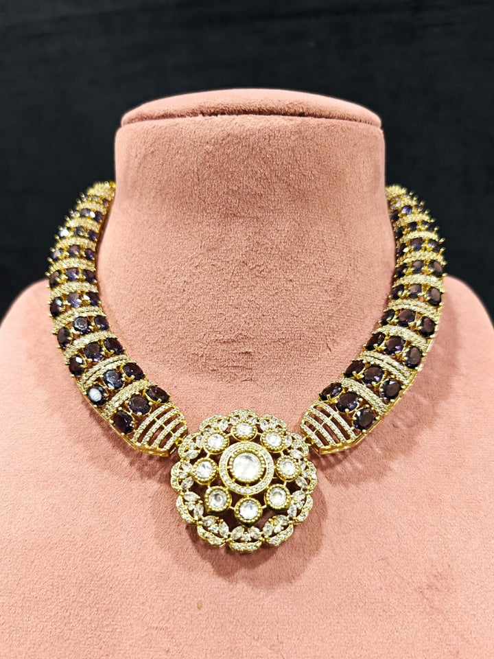 Close-up of an ornate traditional Purple Collar Gold jewellery set and earrings with American Diamond and Colored Stones. Mehendi function outfit styled with a lightweight American Diamond necklace. Festive celebration look featuring a American Diamond artificial necklace.