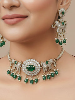 Close-up of a woman wearing an ornate traditional Dark Green (Mehendi gold Polish) Choker Diamond jewellery set and earrings with American Diamond, Colored Stone and Pearls. Elegant festive look with a high-quality imitation American diamond necklace set. A woman wearing a luxury American diamond necklace set styled beautifully for a wedding guest look in India.