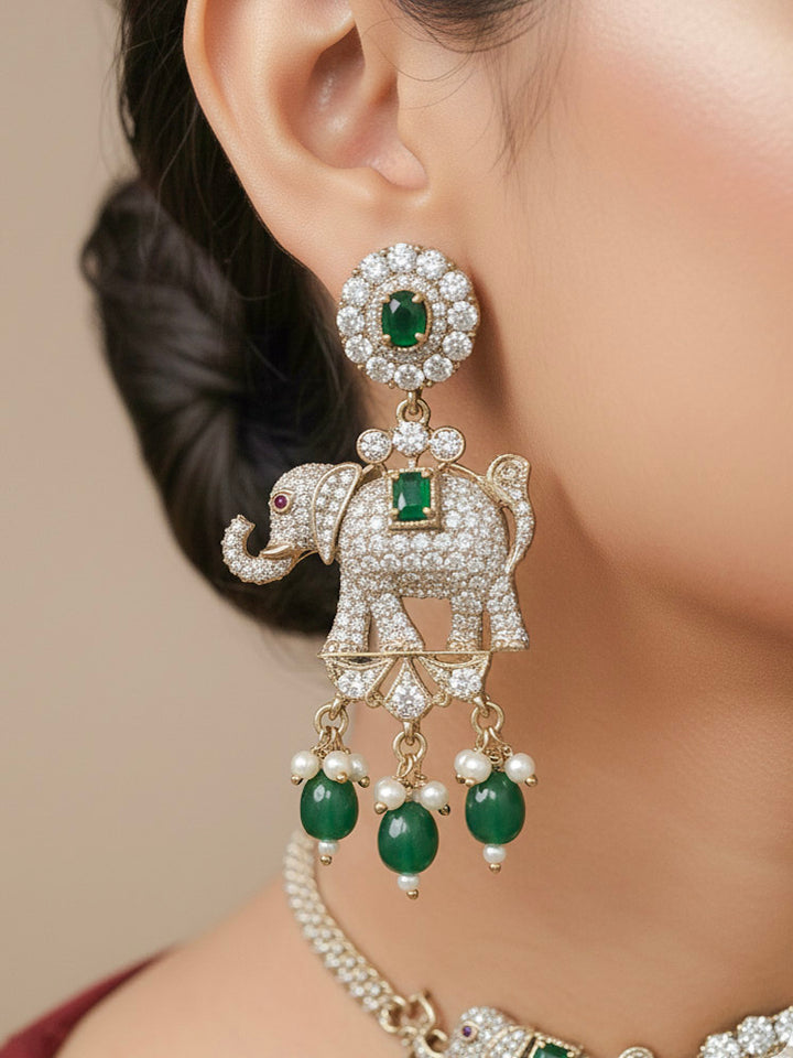 Close-up of a woman wearing an ornate traditional Dark Green (Mehendi gold Polish) Choker Diamond jewellery set and earrings with American Diamond, Colored Stone and Pearls. Elegant festive look with a high-quality imitation American diamond necklace set. A woman wearing a luxury American diamond necklace set styled beautifully for a wedding guest look in India.