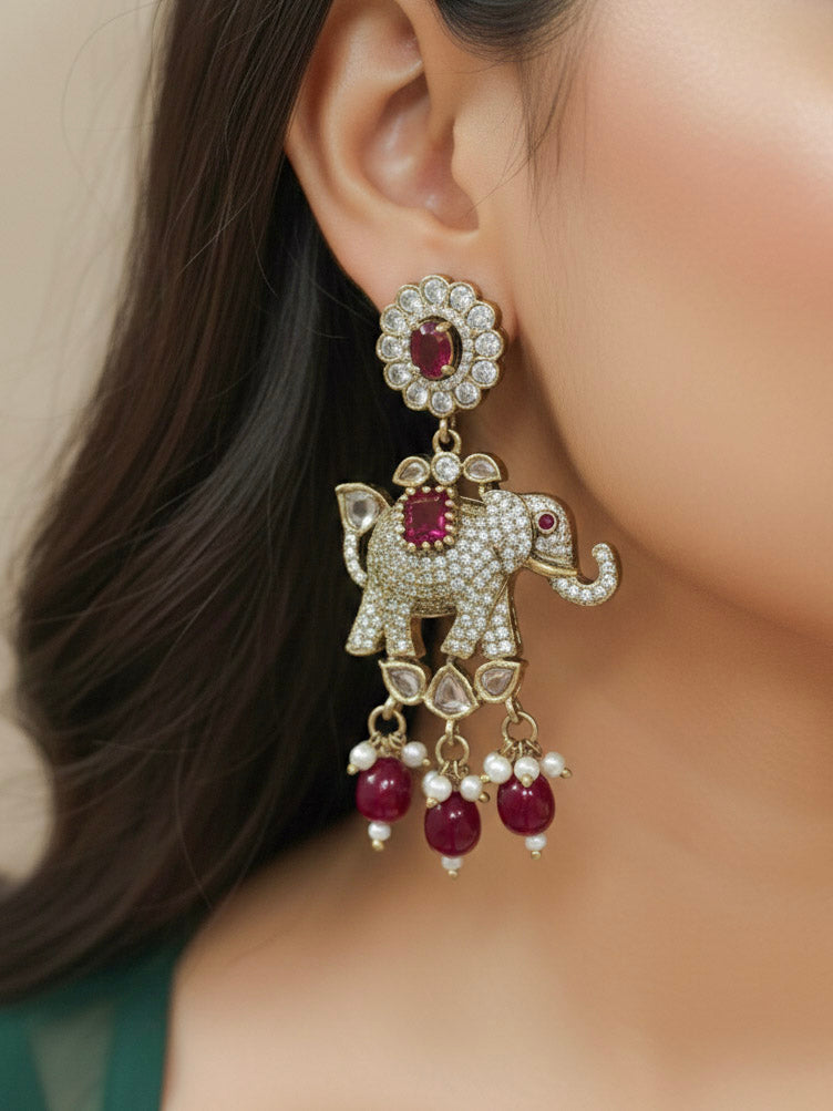 Close-up of a woman wearing an ornate traditional Maroon (Mehendi gold Polish) Choker Diamond jewellery set and earrings with American Diamond, Pearls and Colored Stone. Elegant festive look with a high-quality imitation American diamond necklace set. A woman wearing a luxury American diamond necklace set styled beautifully for a wedding guest look in India.