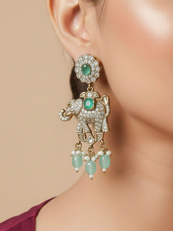 Close-up of a woman wearing an ornate traditional Mint Green (Mehendi gold Polish) Choker Diamond jewellery set and earrings with American Diamond, Pearls and Colored Stone. Elegant festive look with a high-quality imitation American diamond necklace set. A woman wearing a luxury American diamond necklace set styled beautifully for a wedding guest look in India.
