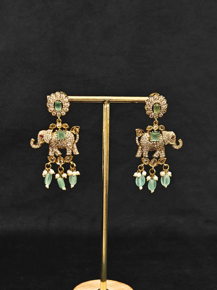 Close-up of an ornate traditional Mint Green (Mehendi gold Polish) Choker Diamond jewellery set and earrings with American Diamond, Pearls and Colored Stone. Elegant festive look with a high-quality imitation American diamond necklace set. A luxury American diamond necklace set styled beautifully for a wedding guest look in India.