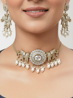 Close-up of a woman wearing an ornate traditional White (Mehendi gold Polish) Choker Diamond jewellery set and earrings with American Diamond and Pearls. Elegant festive look with a high-quality imitation American diamond necklace set. A woman wearing a luxury American diamond necklace set styled beautifully for a wedding guest look in India.