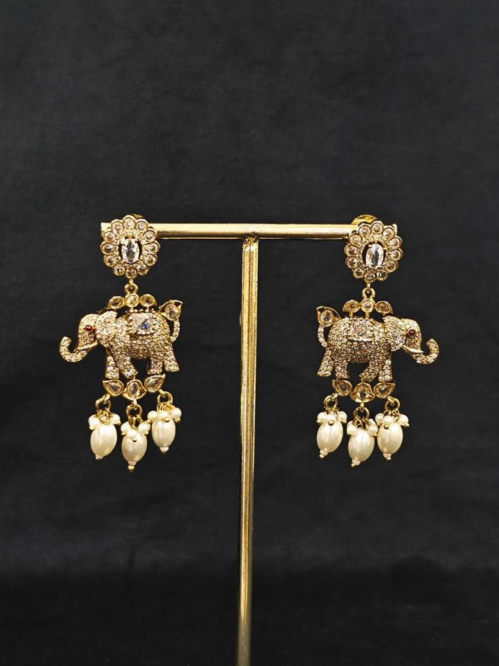 Close-up of an ornate traditional White (Mehendi gold Polish) Choker Diamond jewellery set and earrings with American Diamond and Pearls. Elegant festive look with a high-quality imitation American diamond necklace set. A luxury American diamond necklace set styled beautifully for a wedding guest look in India.
