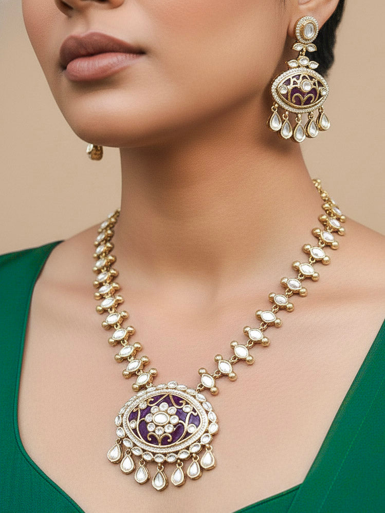 Close-up of a woman wearing an ornate traditional (Mehendi Polish Antique Finish) Dark Purple Collar jewellery set and earrings with Kundan, Monalisa Stone, Colored Stones and American Diamond. Woman wearing trending Kundan artificial jewelry for wedding season in India. Festive Diwali outfit paired with a premium Kundan jewelry piece.
