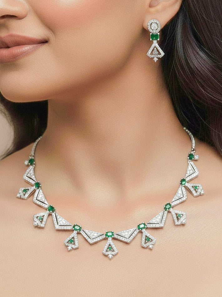 Close-up of a woman wearing an ornate Western Green (Silver Polish) Collar Diamond jewellery set and earrings with American Diamond and Green Colored Stones. Reception-ready look featuring a statement American diamond jewelry set.
Party wear outfit completed with a lightweight American diamond necklace.