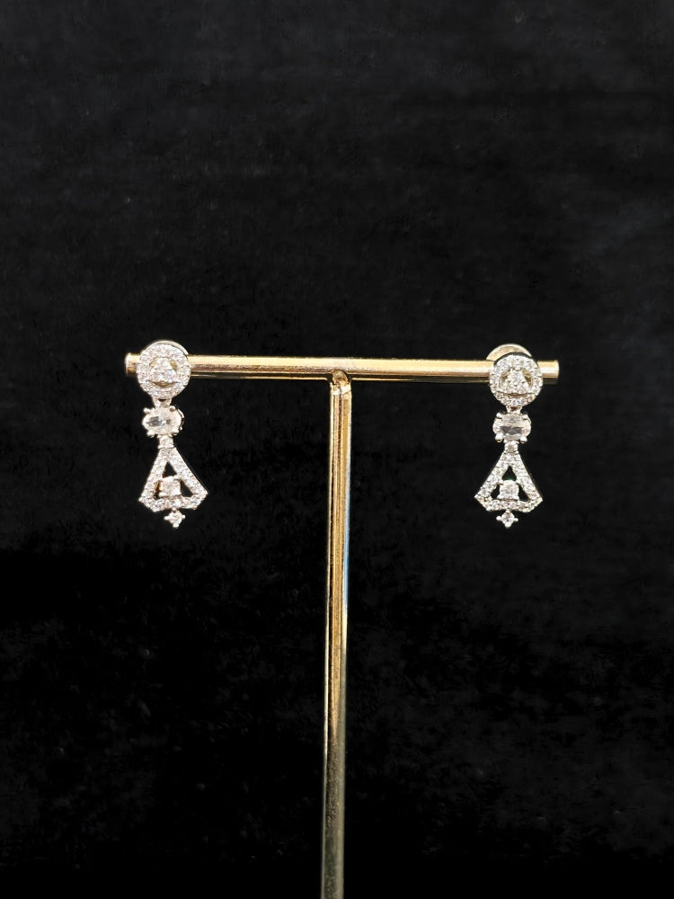 Close-up of an ornate Western White (Silver Polish) Collar Diamond jewellery set and earrings with American Diamond. Reception-ready look featuring a statement American diamond jewelry set. Party wear outfit completed with a lightweight American diamond necklace.