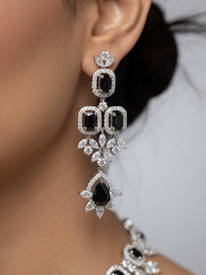 "Close-up of a woman wearing a stunning affordable artificial diamond and black colored stone necklace and matching earrings set, perfect for wedding guests and formal events. This luxury artificial diamond jewelry provides the brilliance of real diamonds at a fraction of the cost."