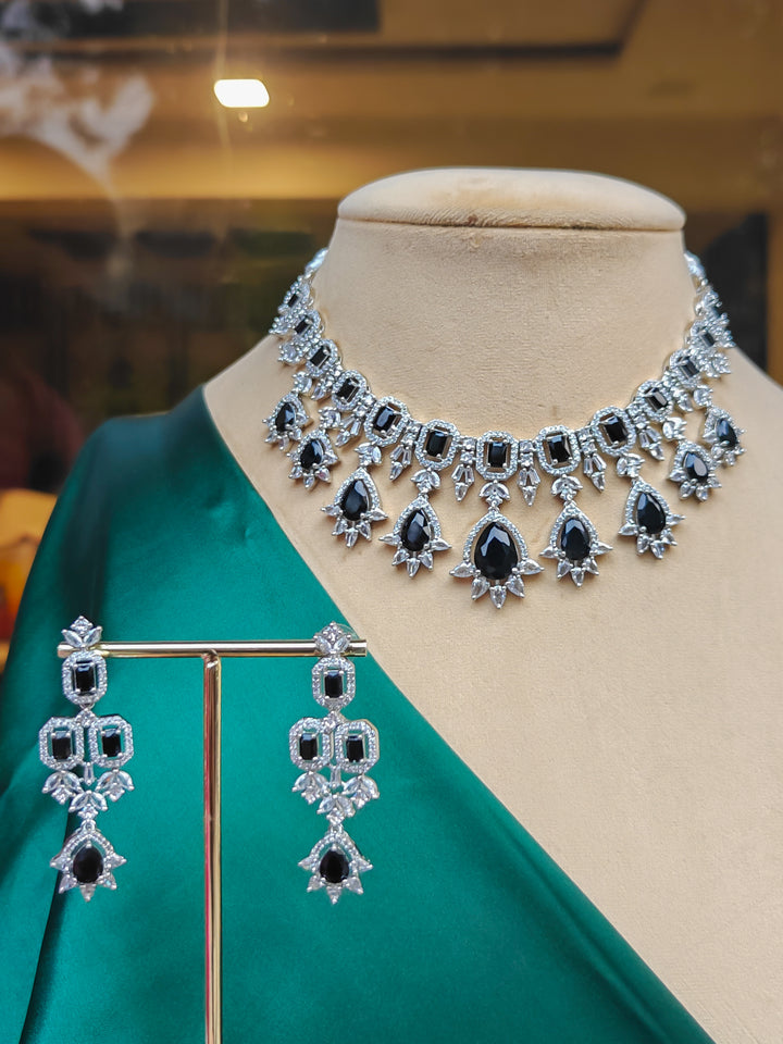 "A stunning woman wearing a glamorous artificial diamond and black colored stone necklace paired with chic earrings, perfect for bridal wear. This high-quality artificial diamond jewelry set is the ideal choice for modern brides looking for a budget-friendly option with timeless sparkle."