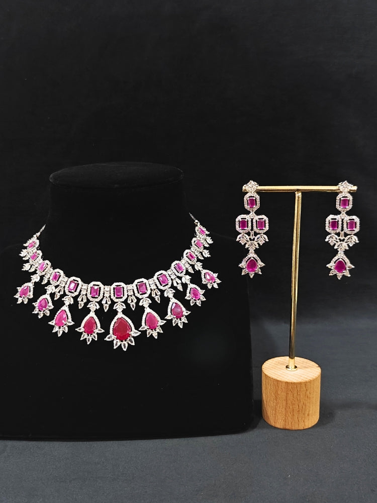 An elegant artificial diamond and pink colored stone necklace and matching earrings. This premium artificial diamond jewelry set is perfect for special occasions, from Indian weddings to engagement parties, offering sophisticated glamour without the high price tag.
