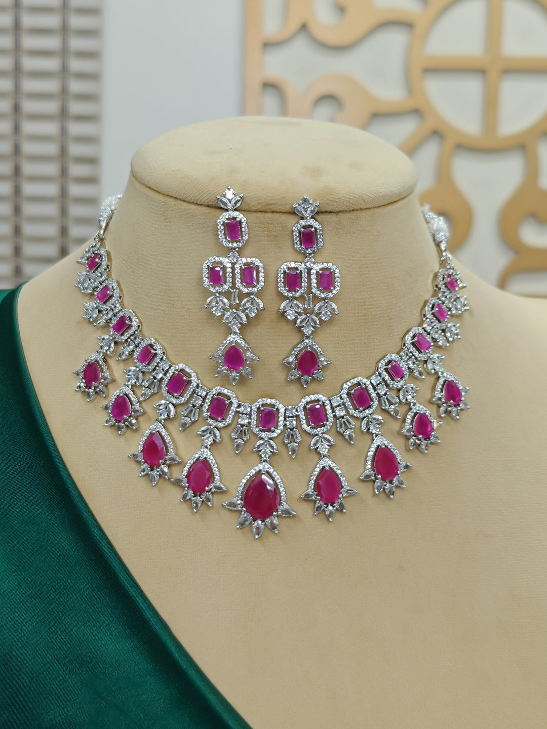 "Close-up of a woman wearing a sparkling artificial diamond and pink colored stone necklace and diamond earrings set, designed to offer a radiant, elegant look for any formal occasion or Indian wedding. This affordable diamond jewelry provides a flawless, luxurious alternative to natural diamonds."