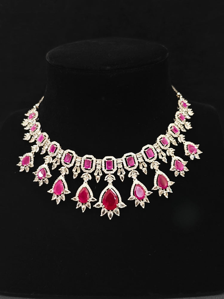 An elegant artificial diamond and pink colored stone necklace and matching earrings. This premium artificial diamond jewelry set is perfect for special occasions, from Indian weddings to engagement parties, offering sophisticated glamour without the high price tag.