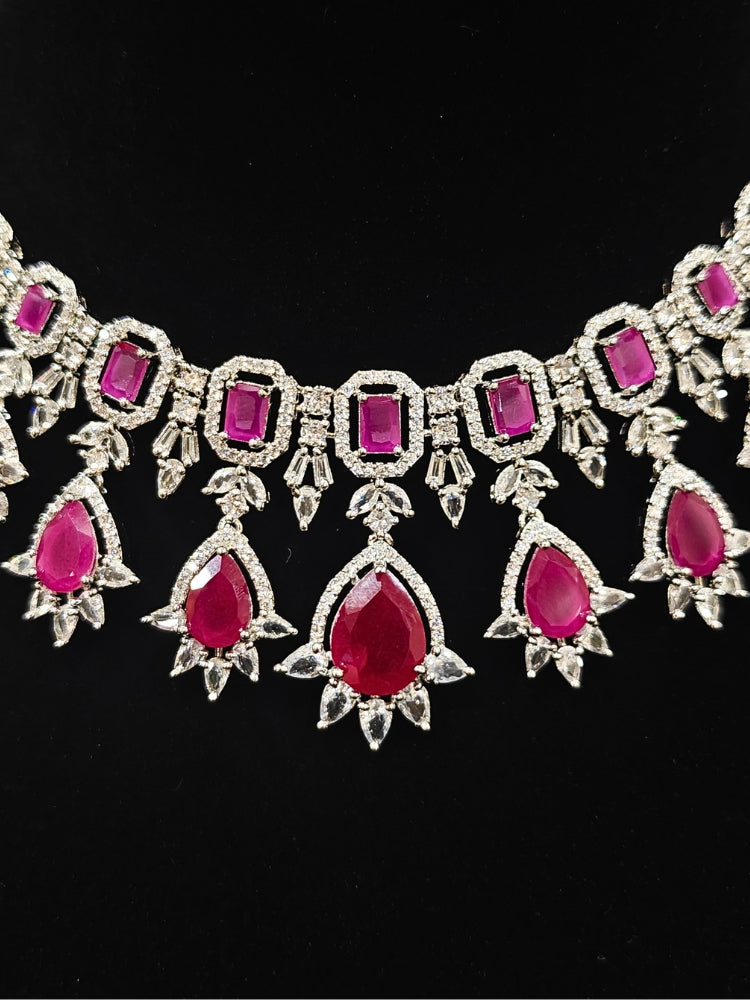 An elegant artificial diamond and pink colored stone necklace and matching earrings. This premium artificial diamond jewelry set is perfect for special occasions, from Indian weddings to engagement parties, offering sophisticated glamour without the high price tag.