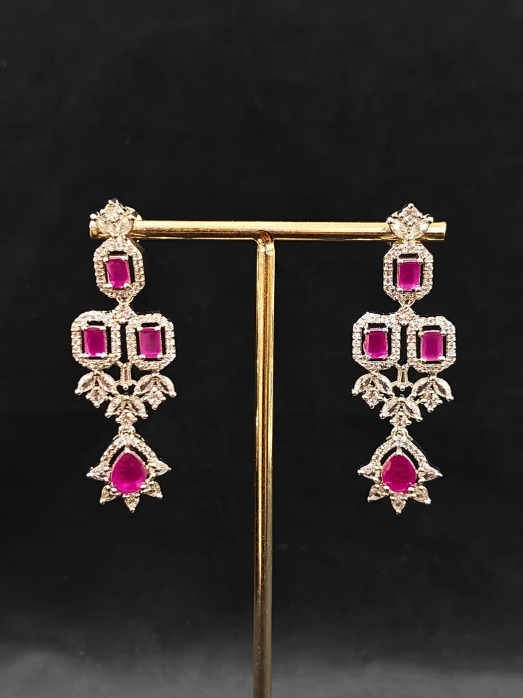 An elegant artificial diamond and pink colored stone necklace and matching earrings. This premium artificial diamond jewelry set is perfect for special occasions, from Indian weddings to engagement parties, offering sophisticated glamour without the high price tag.
