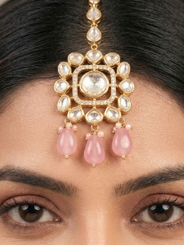 Close-up of a woman wearing an ornate traditional (Gold Polish) Choker jewellery set and earrings with Polki, American Diamond, Colored Stones and Tumble Beads. Wedding guest wearing a statement Polki artificial necklace for a reception party. Woman wearing trending Polki artificial jewelry for the wedding season in India.