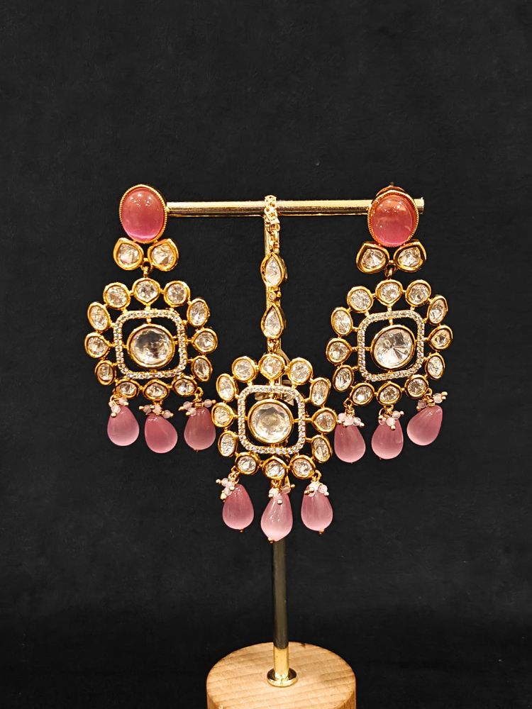 Close-up of an ornate traditional (Gold Polish) Choker jewellery set and earrings with Polki, American Diamond, Colored Stones and Tumble Beads. Wedding guest wearing a statement Polki artificial necklace for a reception party. Woman wearing trending Polki artificial jewelry for the wedding season in India.