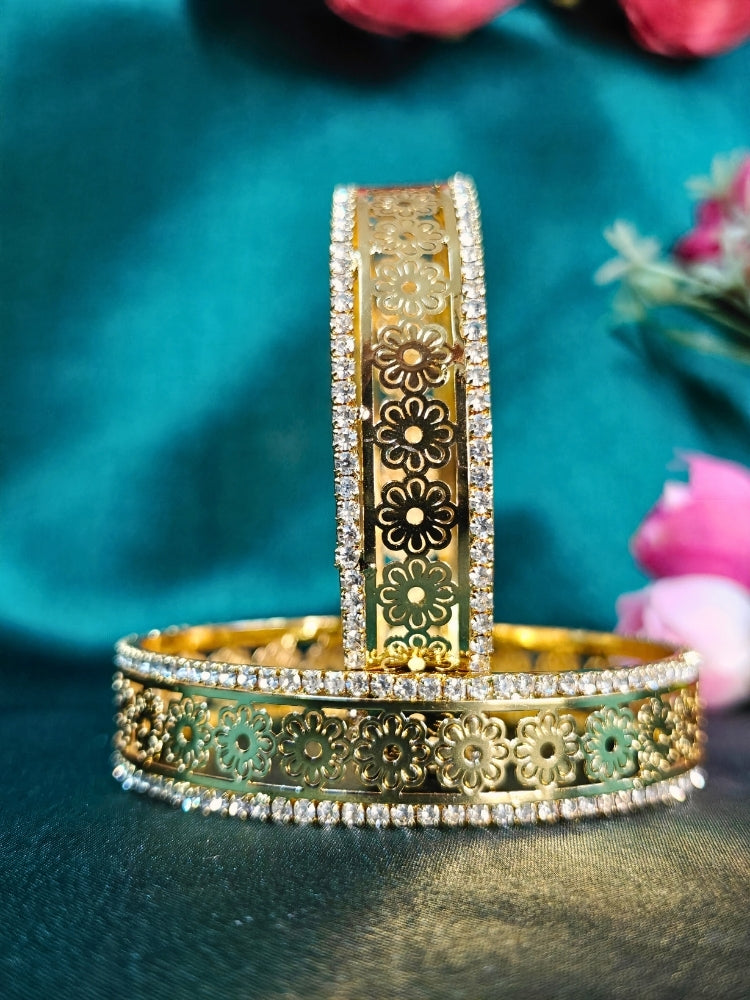 Close-up of an ornate traditional (Gold Polish) Bangles set with American Diamond and Filigree Work. Wedding guest look completed with lightweight artificial American Diamond bangles. Luxury artificial American Diamond bangles styled for a wedding function.
