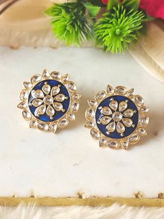 Close-up of an ornate traditional Navy Blue Kundan Studs Earrings with Kundan, Enamel and Meenakari.  Lightweight artificial Kundan Studs earrings for Wedding ceremony. Wearing trendy artificial Kundan Studs earrings for a 2026 Festive celebration in India.