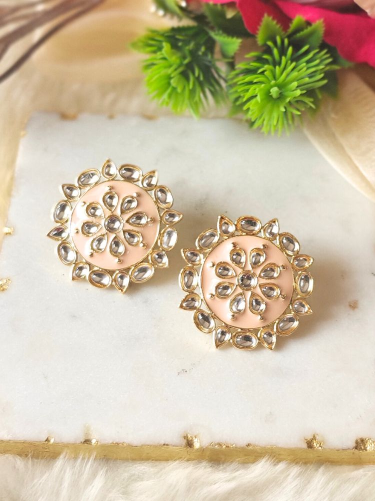 Close-up of an ornate traditional Peach Kundan Studs Earrings with Kundan, Enamel and Meenakari.  Lightweight artificial Kundan Studs earrings for Wedding ceremony. Wearing trendy artificial Kundan Studs earrings for a 2026 Festive celebration in India.