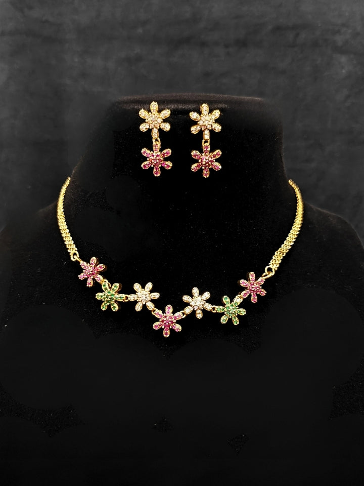 Close-up of an ornate Indo-western (Mehendi Gold Antique Finish Polish) Choker jewellery set and earrings American Diamond and Colored Stones. A lightweight American diamond necklace perfect for long wedding functions. Close-up of  featuring an anti-tarnish American diamond artificial necklace.