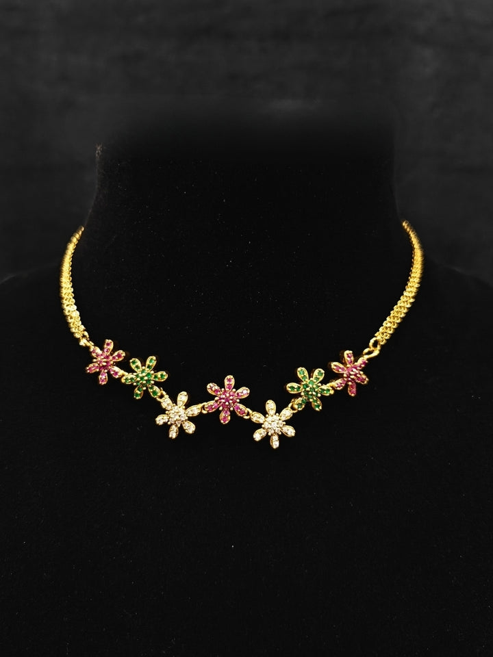 Close-up of an ornate Indo-western (Mehendi Gold Antique Finish Polish) Choker jewellery set and earrings American Diamond and Colored Stones. A lightweight American diamond necklace perfect for long wedding functions. Close-up of  featuring an anti-tarnish American diamond artificial necklace.