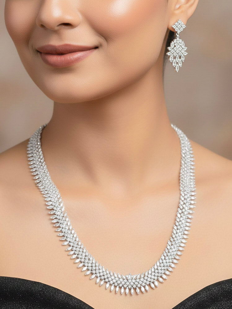 Close-up of a woman wearing an ornate Western Dimaond Silver jewellery set and earrings with American Diamond. Party wear outfit completed with a lightweight American diamond necklace. Woman styling American diamond necklace with an off-shoulder gown for a reception.