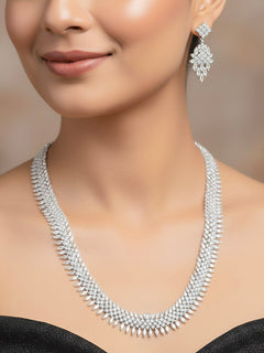 Woman wearing the Avika silver American Diamond necklace set with earrings