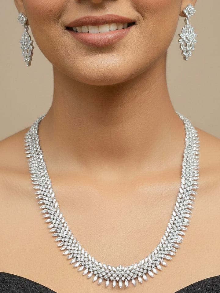 Close-up of a woman wearing an ornate Western Dimaond Silver jewellery set and earrings with American Diamond. Party wear outfit completed with a lightweight American diamond necklace. Woman styling American diamond necklace with an off-shoulder gown for a reception.