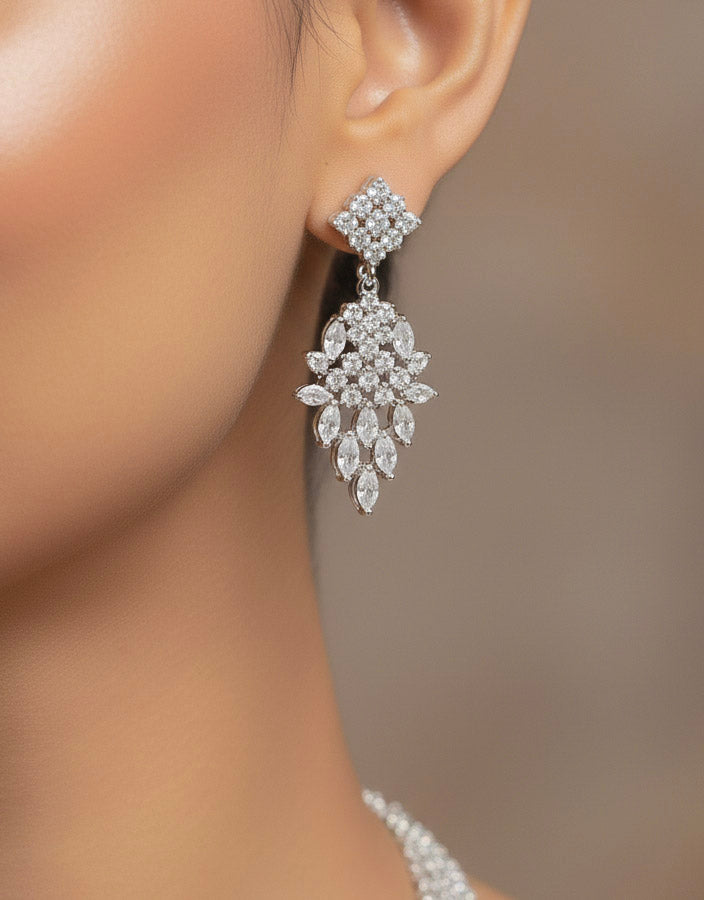Close-up of a woman wearing an ornate Western Dimaond Silver jewellery set and earrings with American Diamond. Party wear outfit completed with a lightweight American diamond necklace. Woman styling American diamond necklace with an off-shoulder gown for a reception.