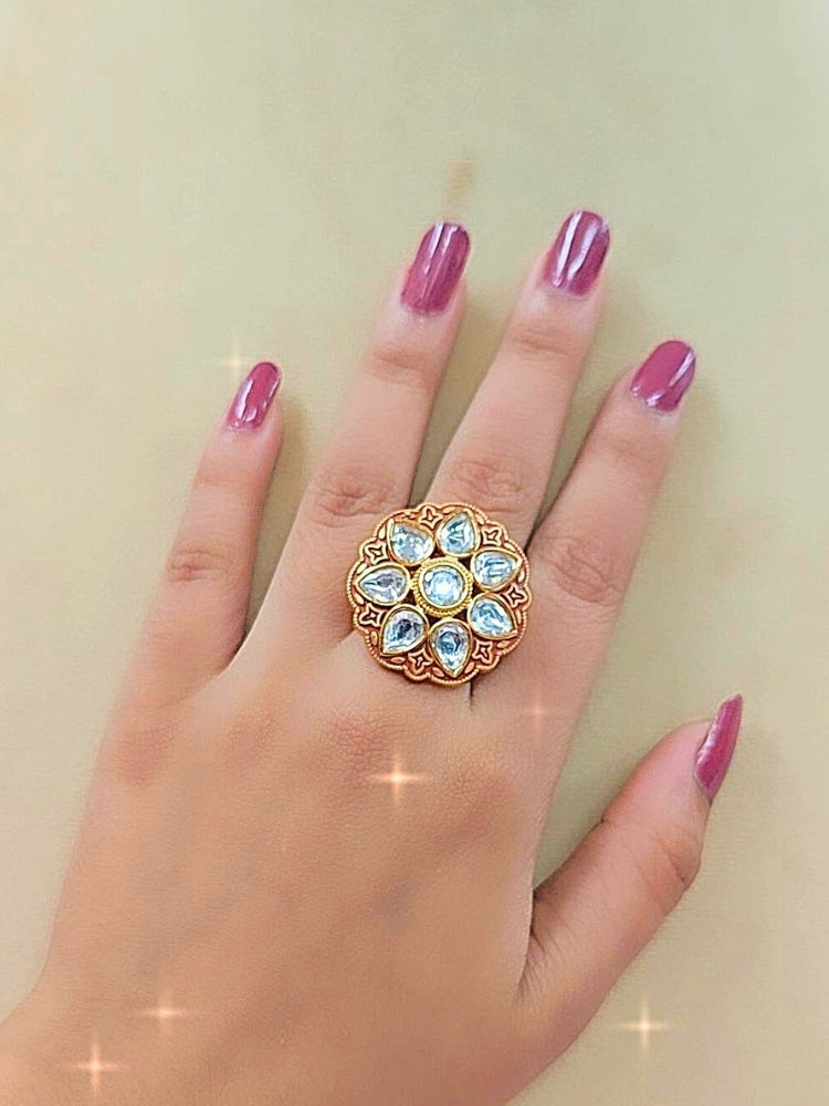 Close-up of a women wearing an ornate traditional Red Meenakari gold Ring with Tyaani Kundan and Meenakari. Saree styling inspiration with a Meenakari Ring. Festive celebration look enhanced with traditional Meenakari Ring.