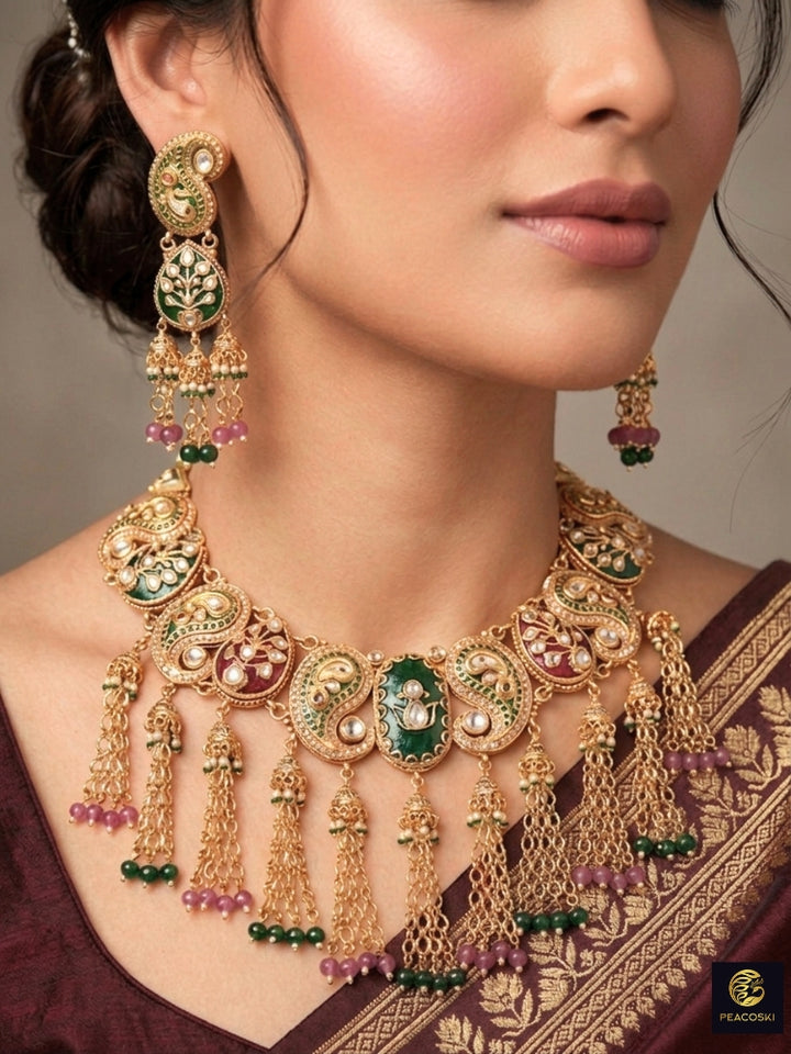 Close-up of a woman wearing an ornate traditional (Gold polish) Green and Mint Pink Collar jewellery set and earrings and maangtikka with Colored Stones, Kundan and Colored Beads. Bride wearing a colorful artificial Colored Stones set for reception night. Wedding function styling with a premium Colored Stone imitation necklace.