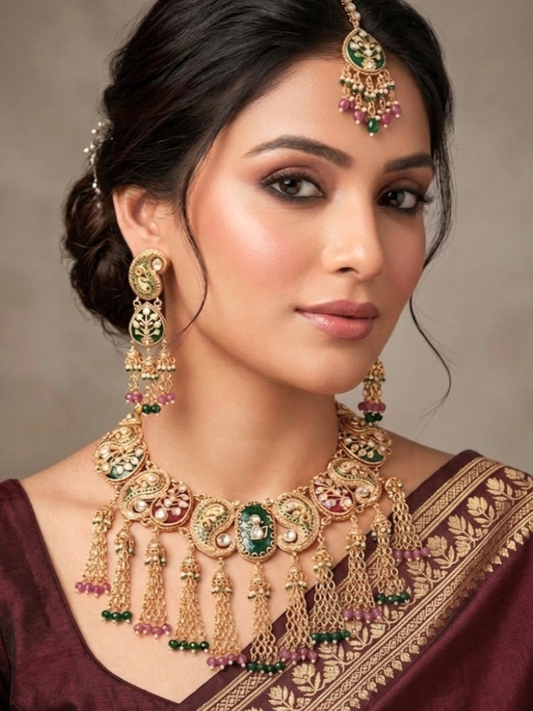 Close-up of a woman wearing an ornate traditional (Gold polish) Green and Mint Pink Collar jewellery set and earrings and maangtikka with Colored Stones, Kundan and Colored Beads. Bride wearing a colorful artificial Colored Stones set for reception night. Wedding function styling with a premium Colored Stone imitation necklace.