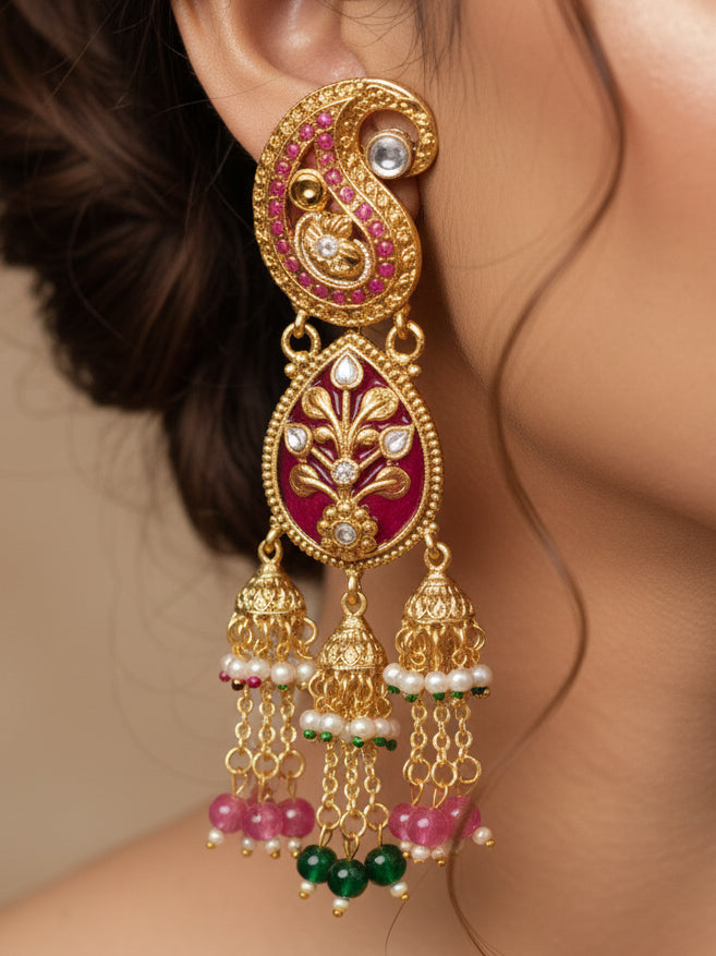 Close-up of a woman wearing an ornate traditional (Gold polish) Green and Mint Pink Collar jewellery set and earrings and maangtikka with Colored Stones, Kundan and Colored Beads. Bride wearing a colorful artificial Colored Stones set for reception night. Wedding function styling with a premium Colored Stone imitation necklace.