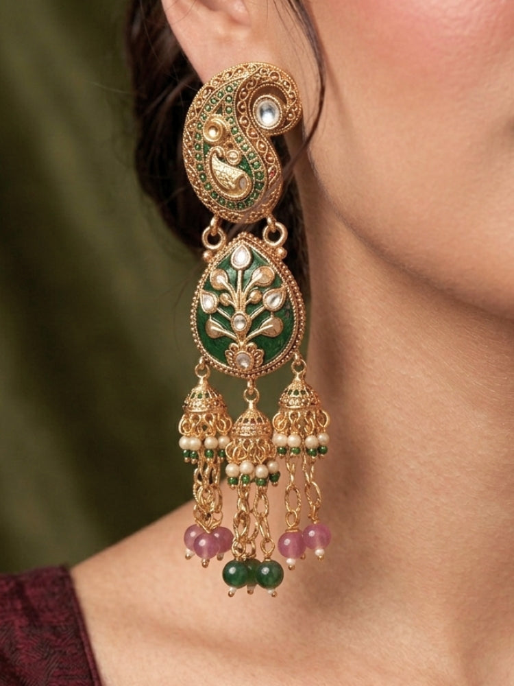 Close-up of a woman wearing an ornate traditional (Gold polish) Green and Mint Pink Collar jewellery set and earrings and maangtikka with Colored Stones, Kundan and Colored Beads. Bride wearing a colorful artificial Colored Stones set for reception night. Wedding function styling with a premium Colored Stone imitation necklace.