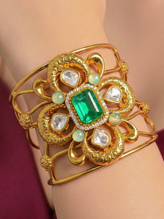 Close-up of a woman wearing an ornate traditional (Gold Polish) Mint Green Bracelet with  American Diamonds and Colored Stones. Festive Diwali outfit paired with a colorful Colored Stone Bracelet. Wedding function styling with a premium Colored Stone imitation Bracelet.